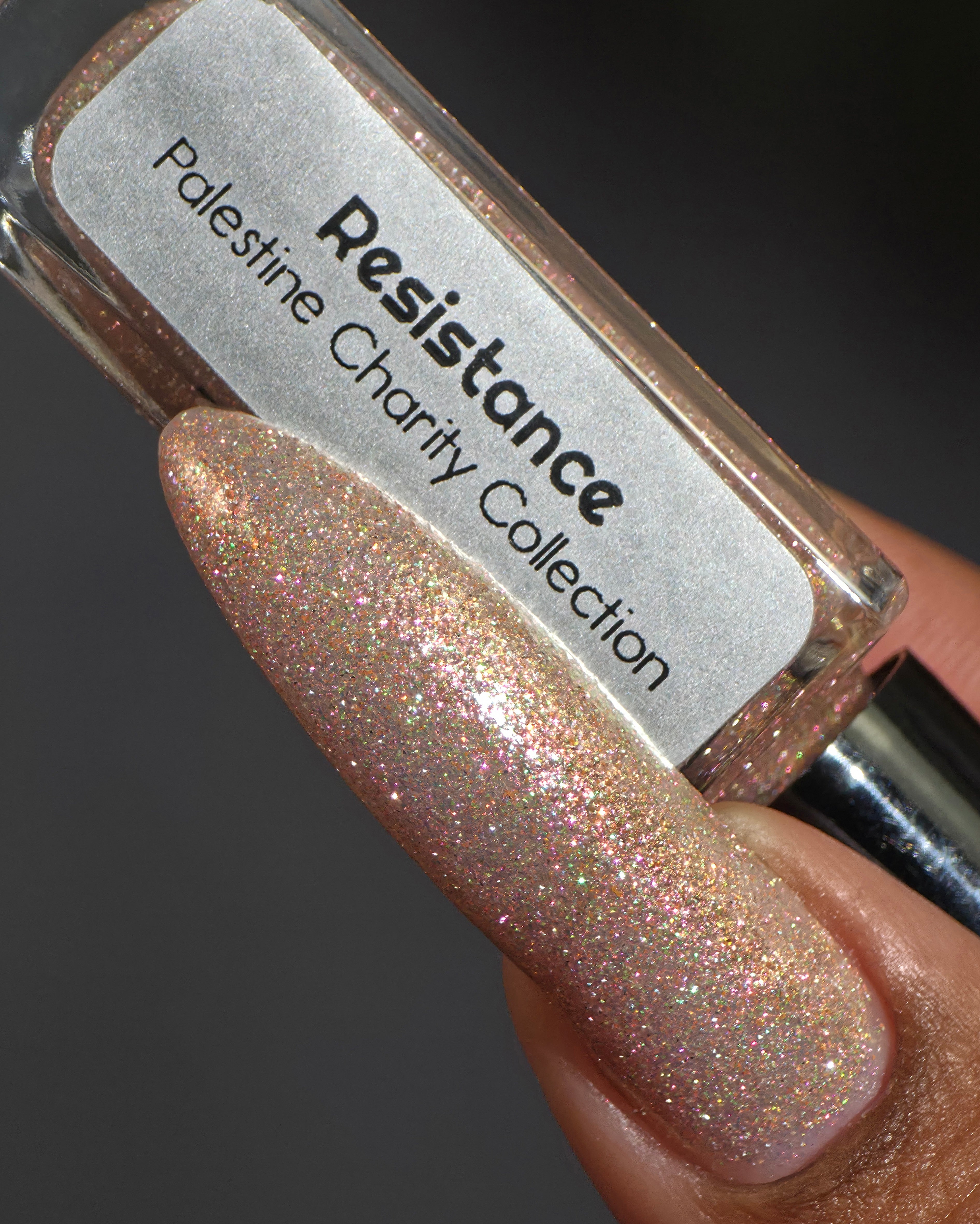 Resistance by Glitch Lacquer, sheer white reflective glitter bottle and swatch on medium skin tone