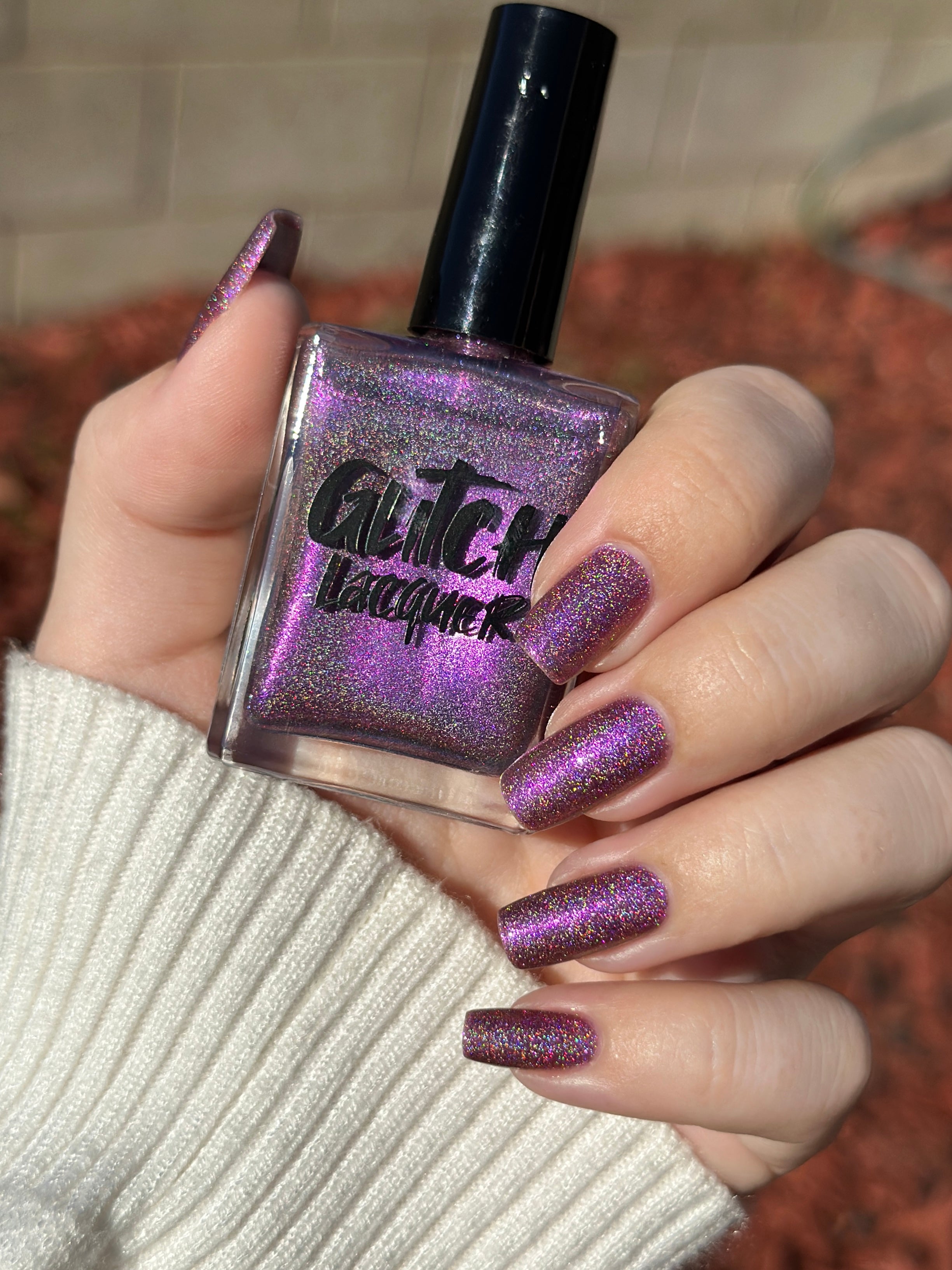 Keys to the Kingdom by Glitch Lacquer, berry multichrome holo bottle and swatch, light skin tone