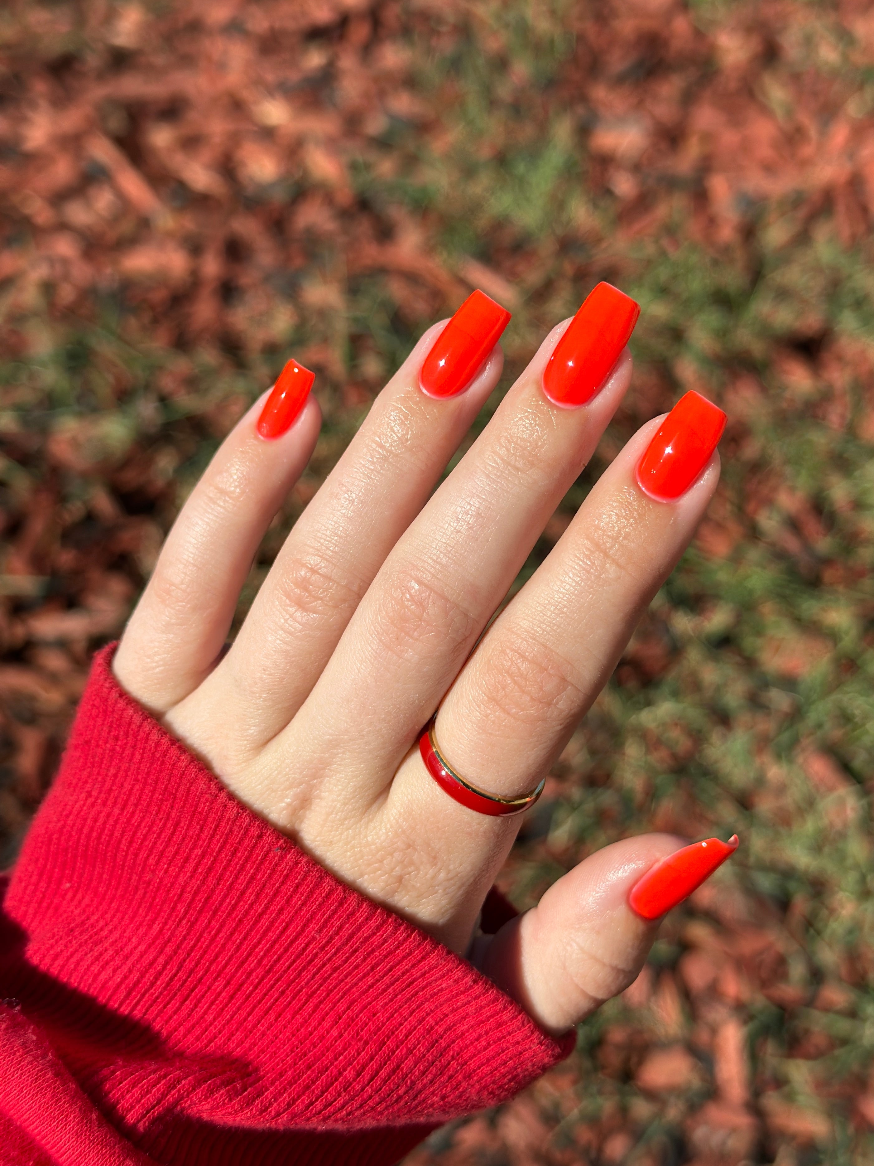 Palestinian Poppy by Glitch Lacquer, warm red crelly swatch on light-medium skin tone