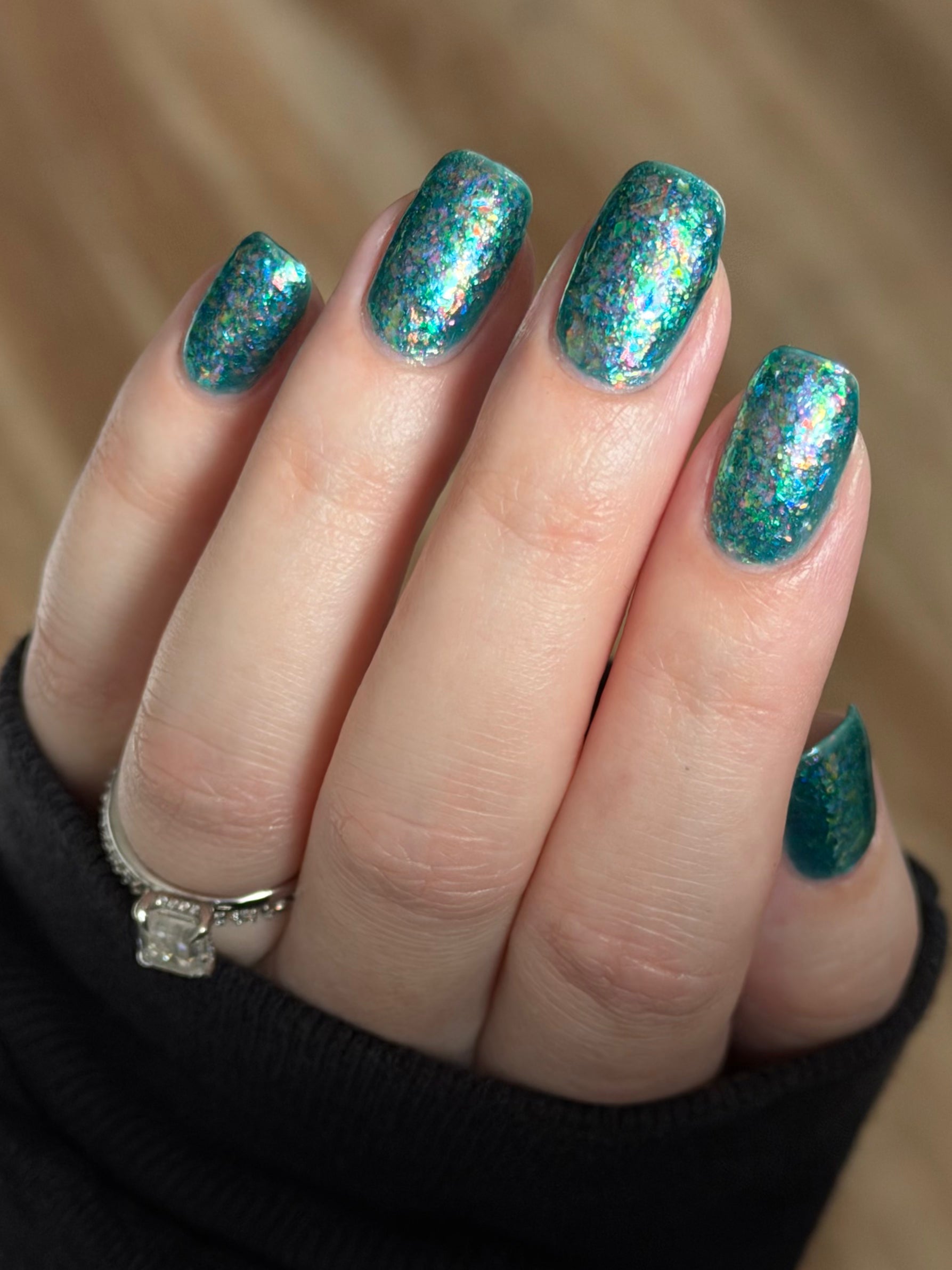 Medo by Glitch Lacquer, teal jelly with iridescent flakies on light skin, squoval nails