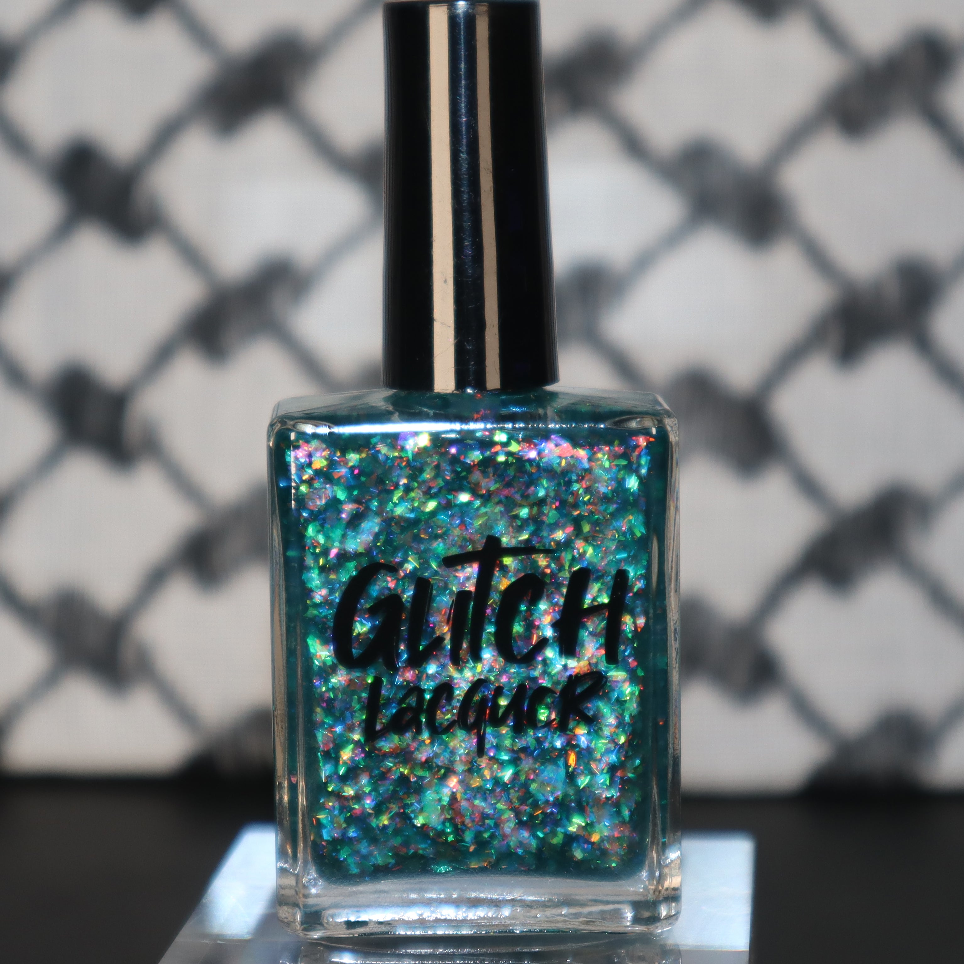 Medo by Glitch Lacquer, teal jelly with iridescent flakies bottle standalone product shot