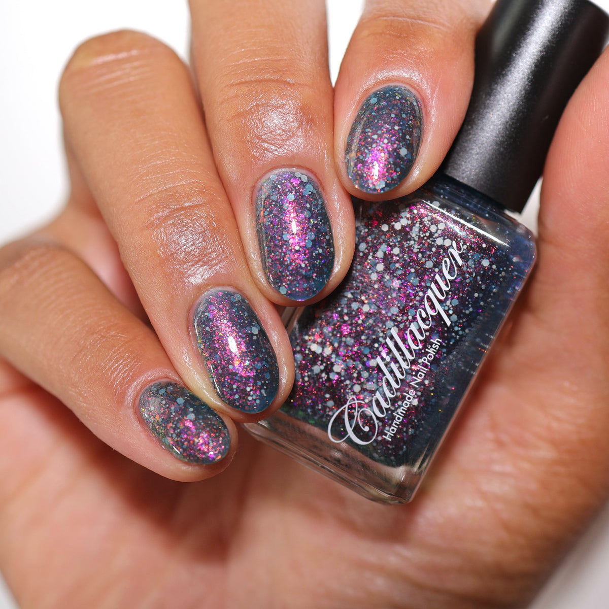 Cadillacquer I Don't Belong To You nail polish swatched with bottle, blue jelly with matte grey glitter