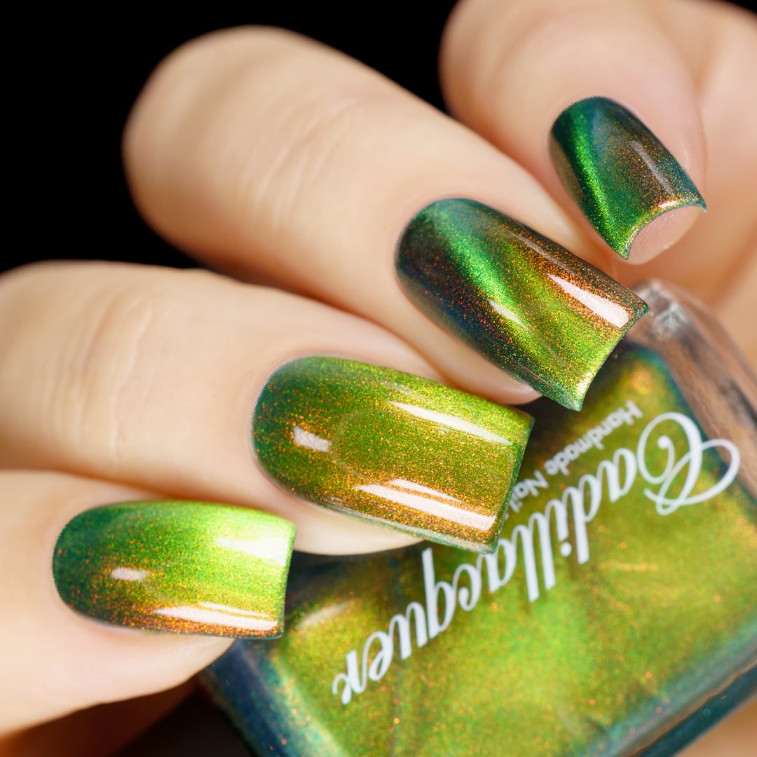 Magnetic multichrome shimmer Cadillacquer nail polish in I Found A Place, swatched on four short natural nails showing deep forest green field regions with bright lime-chartreuse magnetic cat-eye band stripe and copper-to-red-orange aurora shimmer, light skin tone, studio lighting against black background, swatched by @yyulia_m