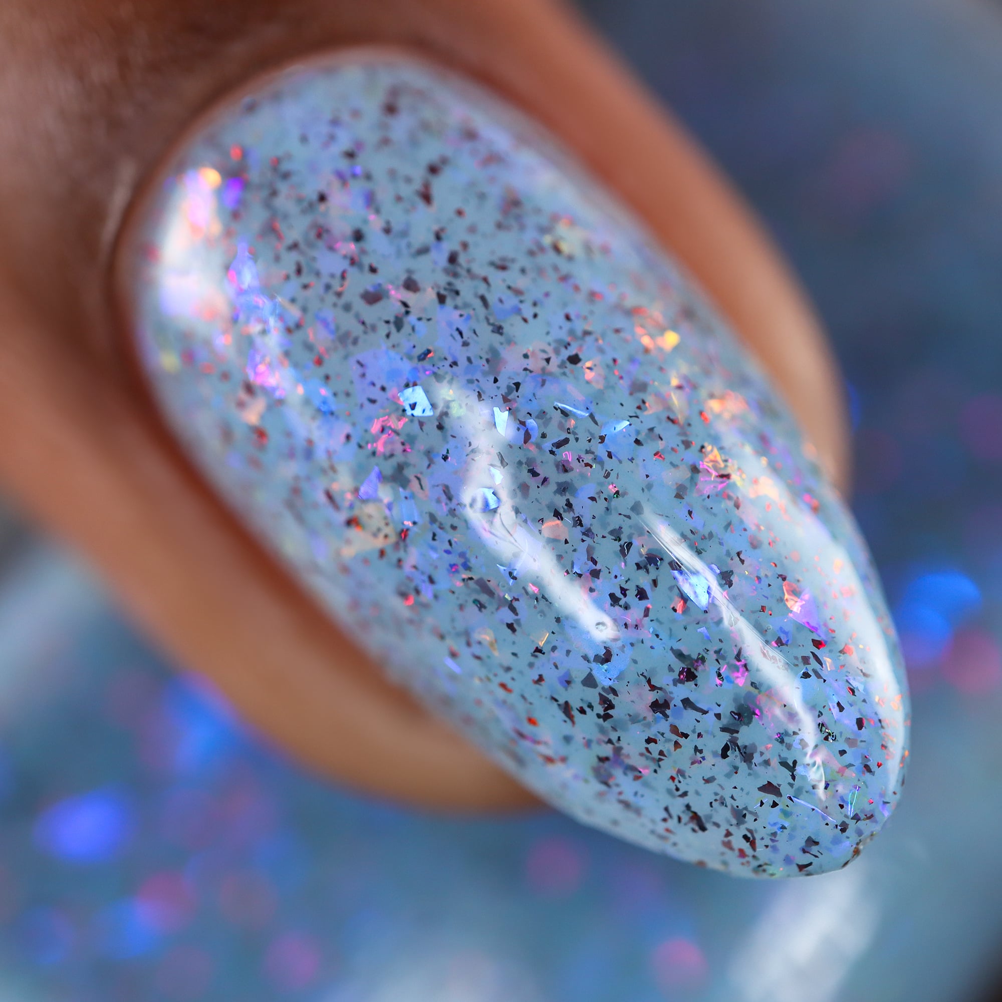 Cadillacquer Just Breathe pastel blue iridescent crelly nail polish, macro single-nail swatch, light-medium skin, studio lighting