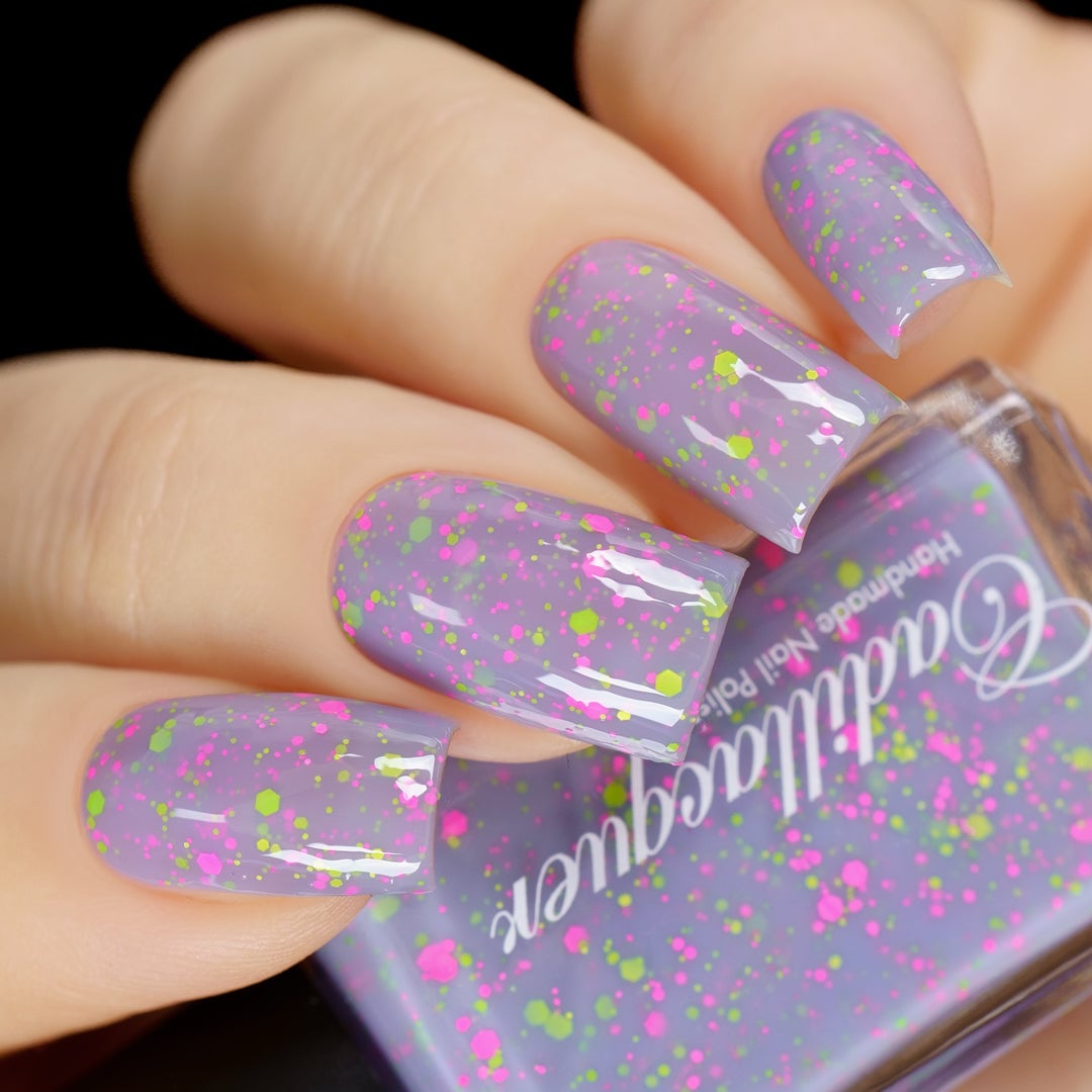 Glitter crelly Cadillacquer nail polish in Magical Creatures, a pastel lilac crelly with matte neon pink and neon green glitter, swatched on nails