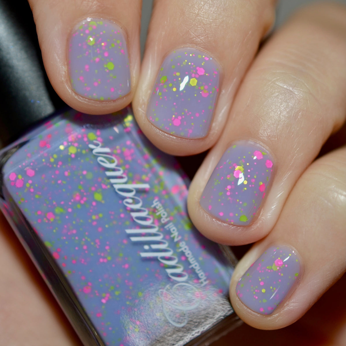 Close-up of Cadillacquer Magical Creatures showing matte neon glitter in lilac crelly base