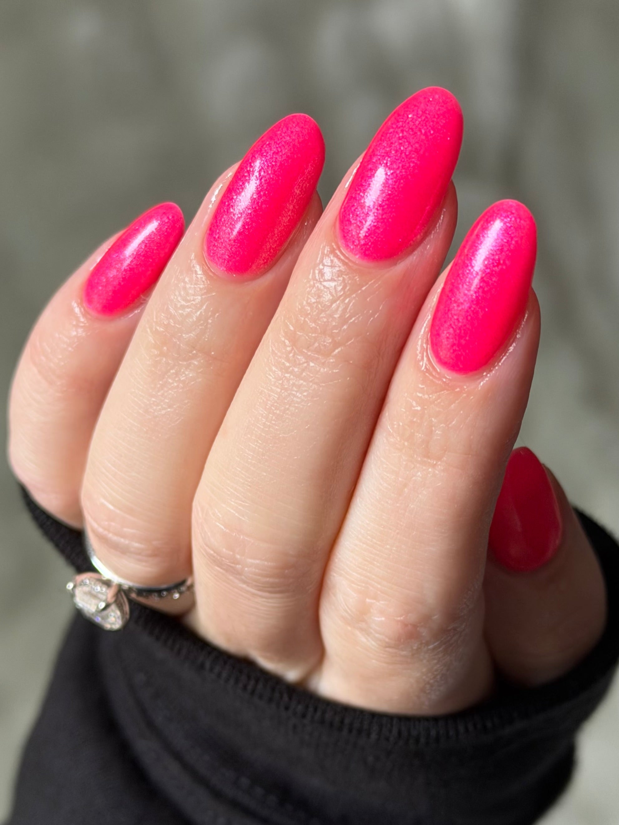 ACT UP by Glitch Lacquer, neon pink crelly with cool-toned pink sparkle, on light skin tone almond nails