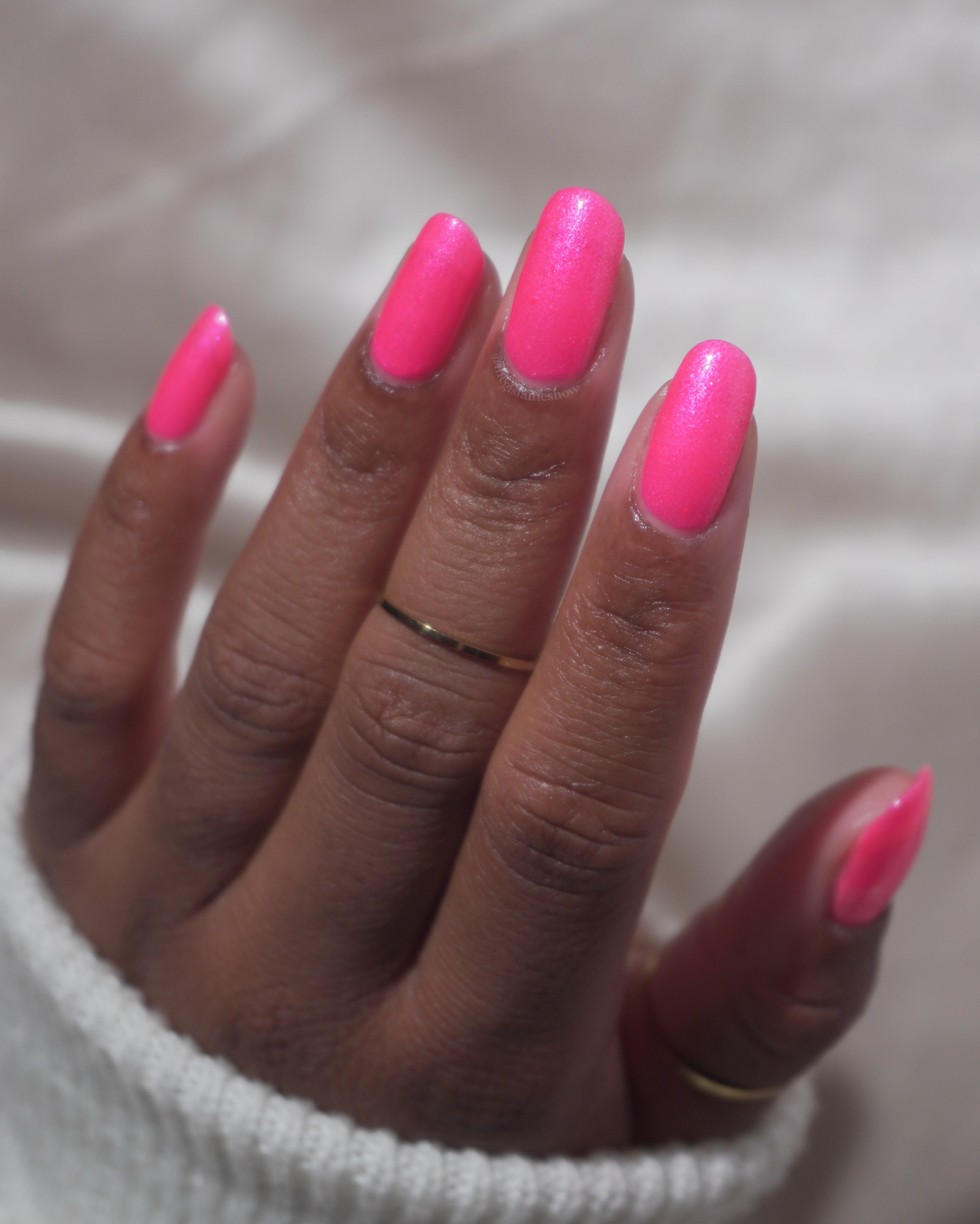 ACT UP by Glitch Lacquer, neon pink crelly with cool-toned pink sparkle, on deep skin tone oval nails