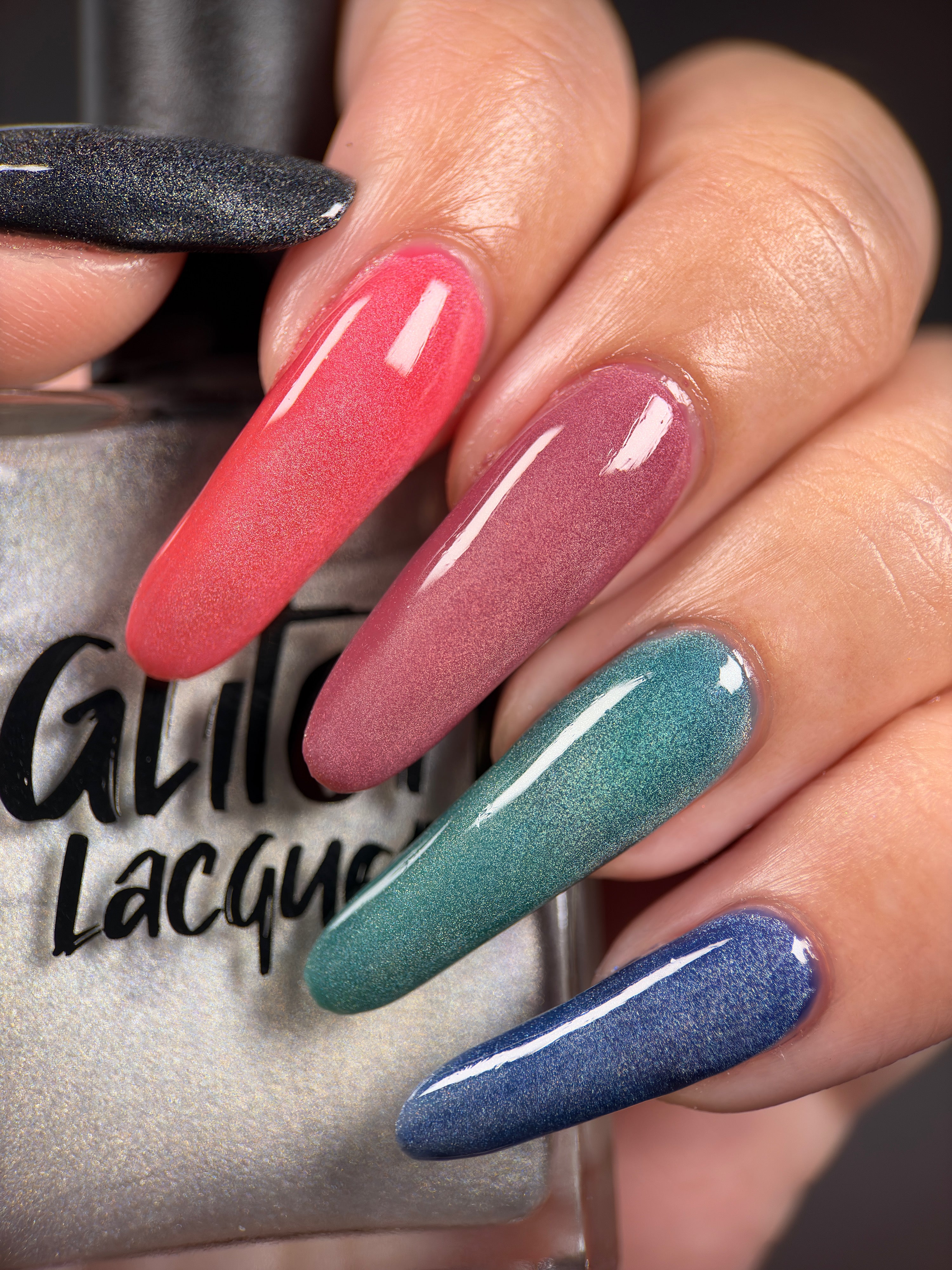 Ally by Glitch Lacquer, silver holographic magnetic topper layered over several base colors, on light-medium skin tone nails