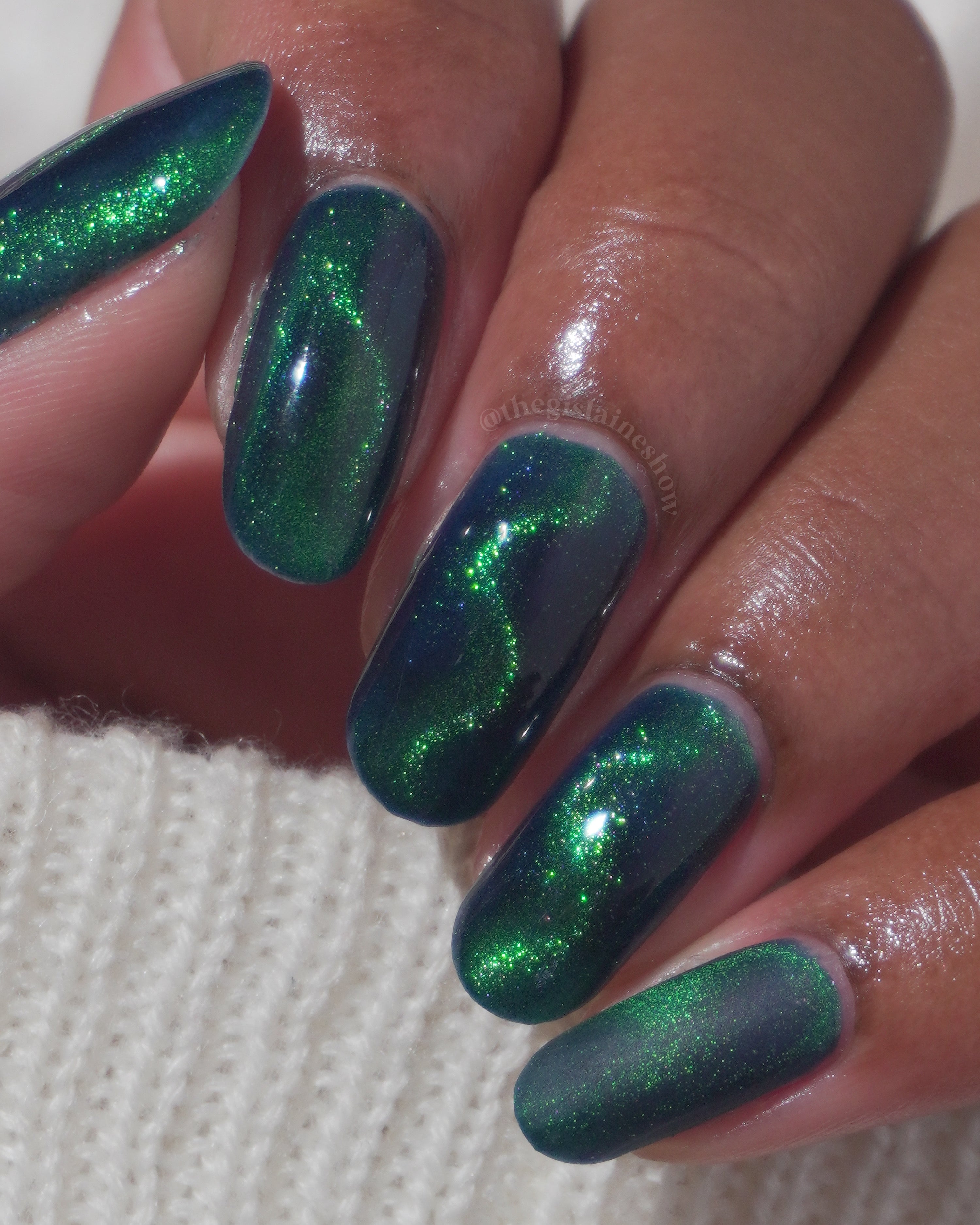 Do-Nuts by Glitch Lacquer, deep blue jelly, green-to-teal magnetic cat-eye, on medium skin tone almond nails