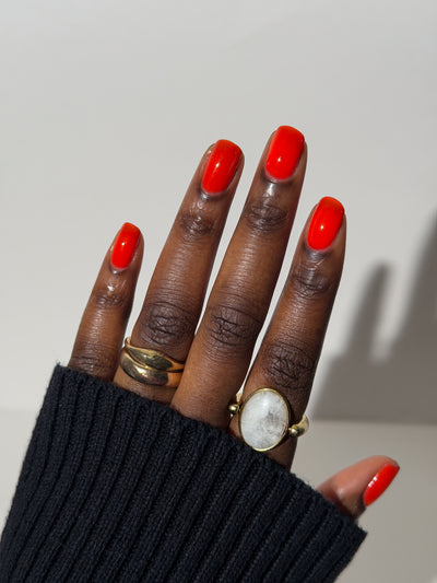 Palestinian Poppy by Glitch Lacquer, warm red crelly swatch on deep skin tone