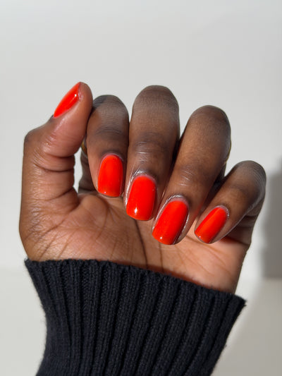 Palestinian Poppy by Glitch Lacquer, warm red crelly swatch on deep skin tone, squoval nails