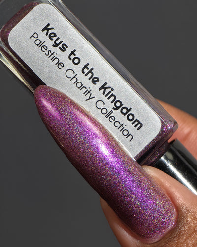 Keys to the Kingdom by Glitch Lacquer, berry multichrome holo bottle and swatch on rich skin tone
