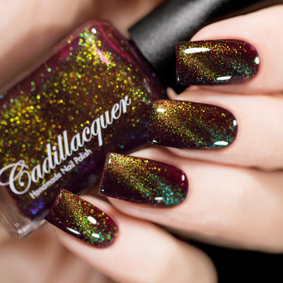 Magnetic flakie Cadillacquer nail polish in Calypso, a deep red jelly with chartreuse to green magnetic flakies, swatched by @rafinails