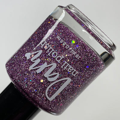 Thistle be the Day by Dam Nail Polish, warm medium purple jelly base with silver-pink holographic glitter scatter and bright reflective micro-glitter, bottle standalone product shot