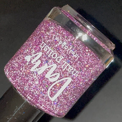 Thistle be the Day by Dam Nail Polish, warm mauve-purple jelly with densely packed silver reflective and holographic glitters sparkling under direct flash, bottle standalone product shot