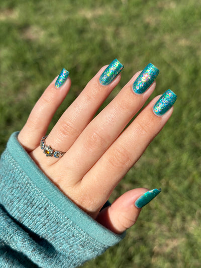 Medo by Glitch Lacquer, teal jelly with iridescent flakies on light skin, square-round nails