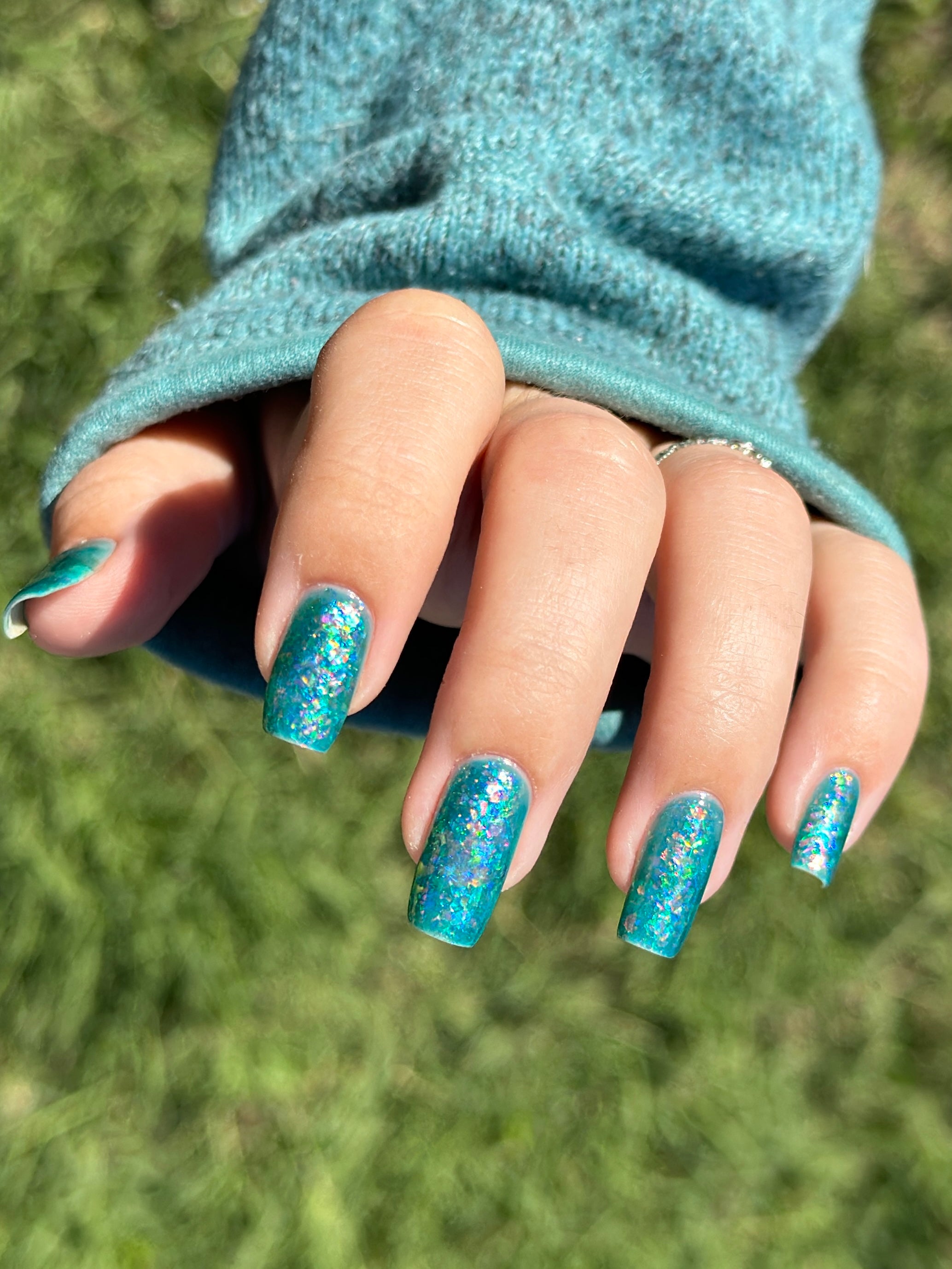 Medo by Glitch Lacquer, teal jelly with iridescent flakies on light-medium skin, squoval nails