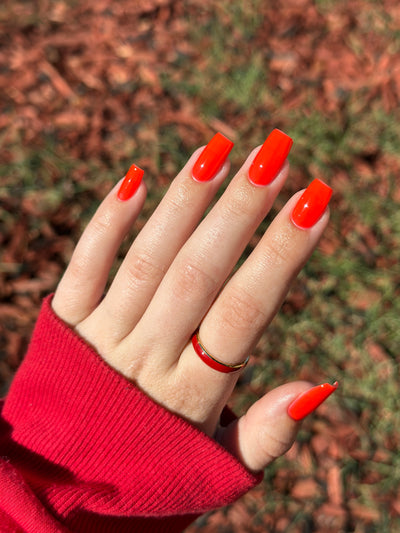 Palestinian Poppy by Glitch Lacquer, warm red crelly swatch on light-medium skin tone