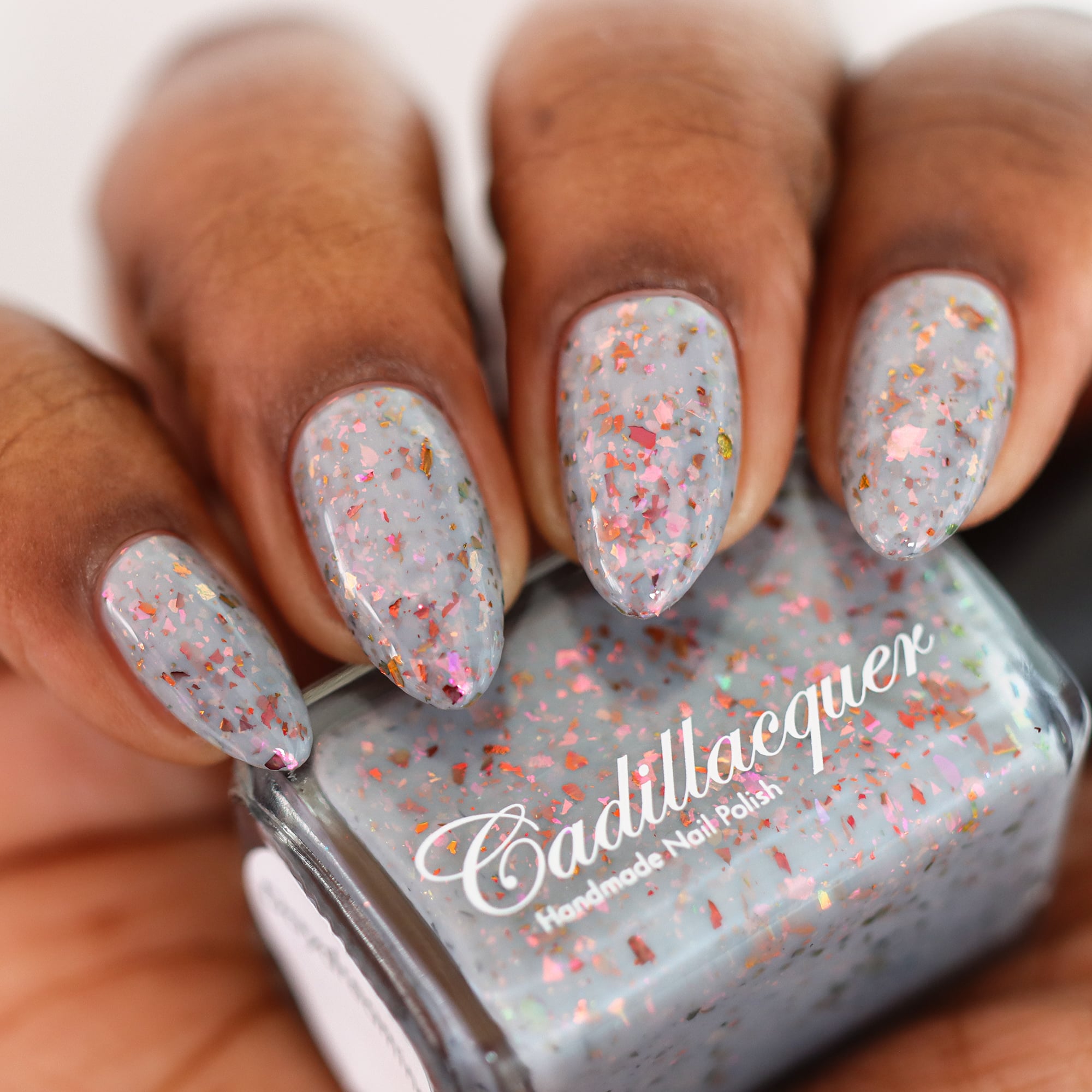 Cadillacquer Daydreaming grey red chameleon iridescent crelly nail polish, swatched on four nails, deep skin, studio lighting