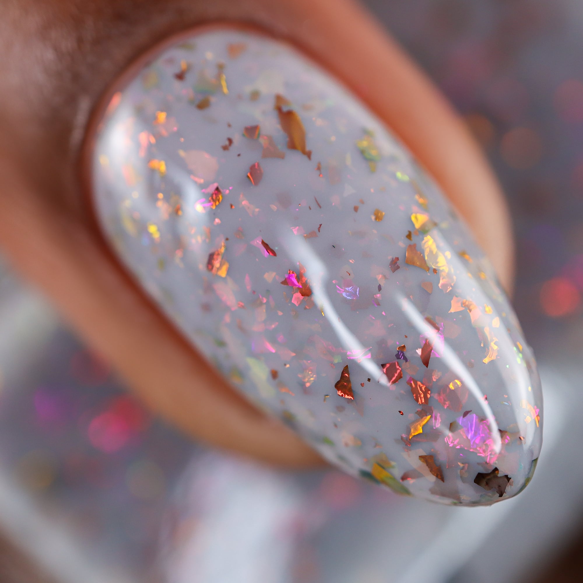 Cadillacquer Daydreaming grey red chameleon iridescent crelly nail polish, macro single-nail swatch, light skin, studio lighting