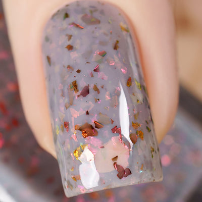 Cadillacquer Daydreaming grey red chameleon iridescent crelly nail polish, macro single-nail swatch, light skin, studio lighting