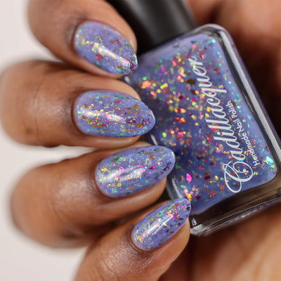 Cadillacquer Don't Worry purple pink chameleon iridescent crelly nail polish, bottle held with four-nail swatch, deep skin, studio lighting