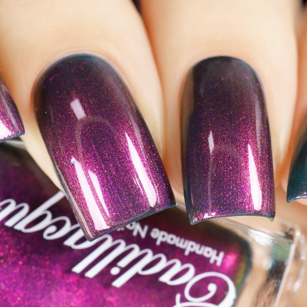 Holographic shimmer Cadillacquer nail polish in Fear What You Will Become, shown swatched on four short natural nails with a deep dark teal-purple base densely packed with magenta and orange holographic shimmer, light skin tone, studio lighting, swatched by @yyulia_m