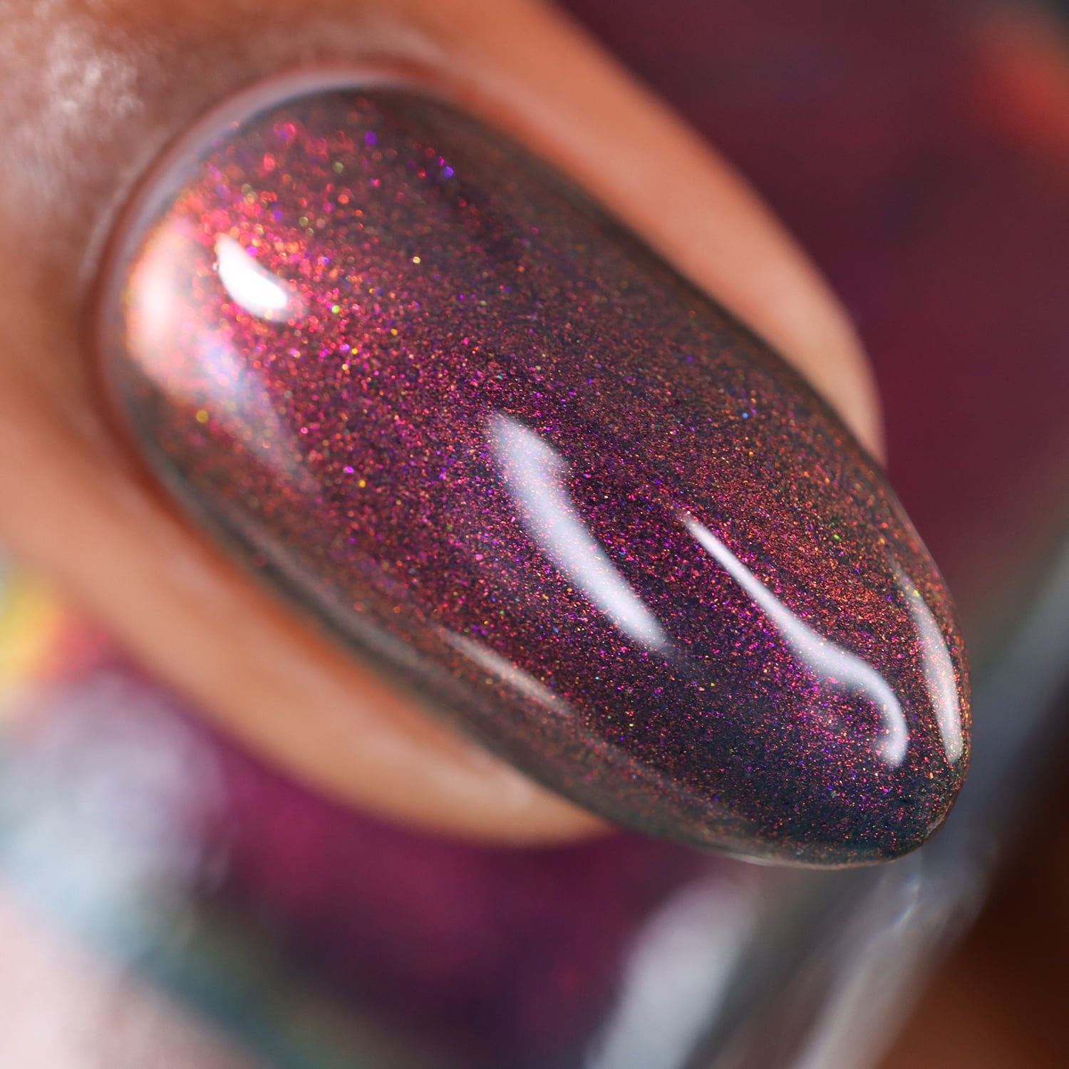 Holographic shimmer Cadillacquer nail polish in Fear What You Will Become, close macro swatch on a single oval nail showing a very dark blackened base densely packed with copper-red, magenta and golden holographic shimmer particles, on medium skin tone, studio lighting, swatched by @doseoflolade