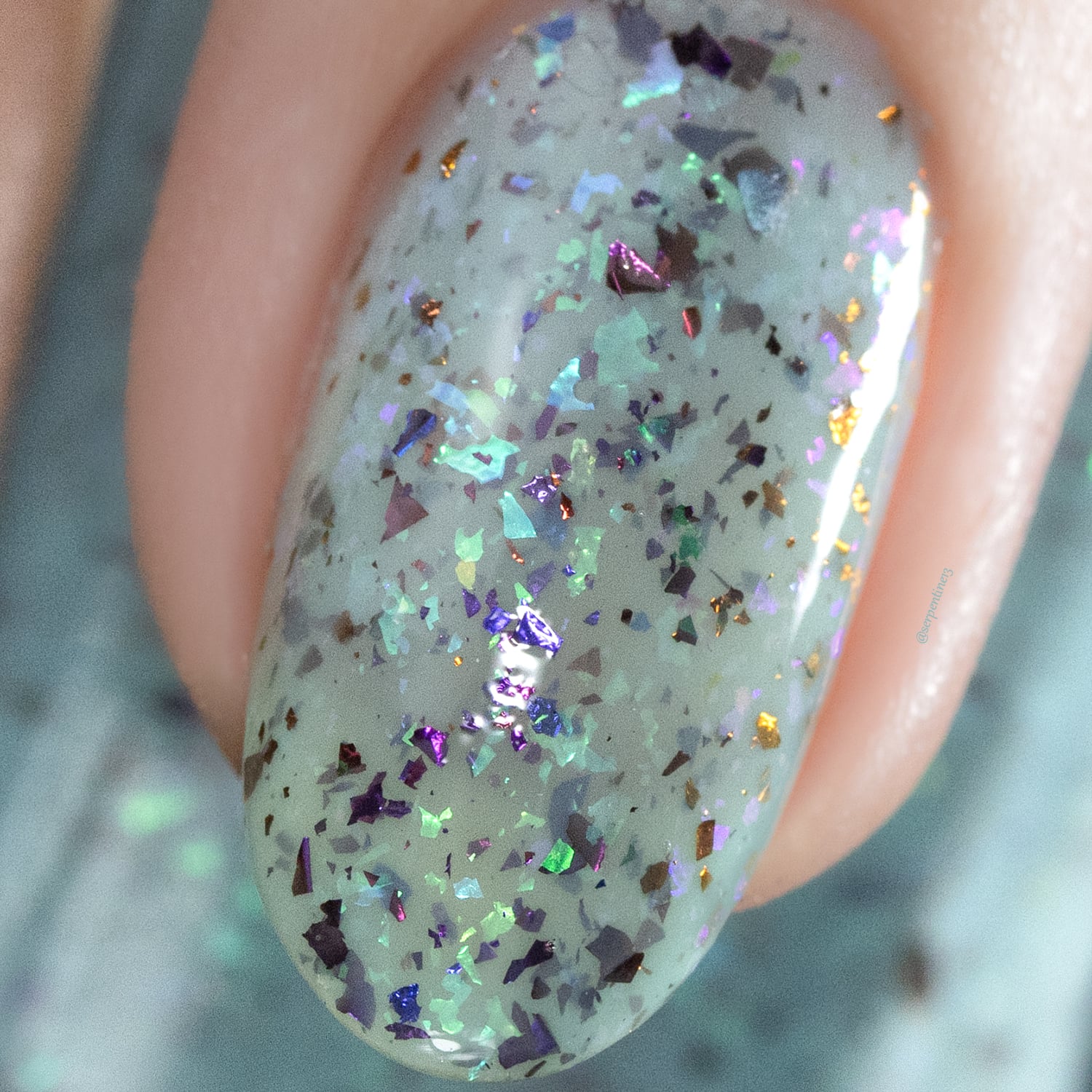 Cadillacquer Pastel Thoughts pastel teal purple chameleon iridescent crelly nail polish, macro single-nail swatch, light skin, studio lighting