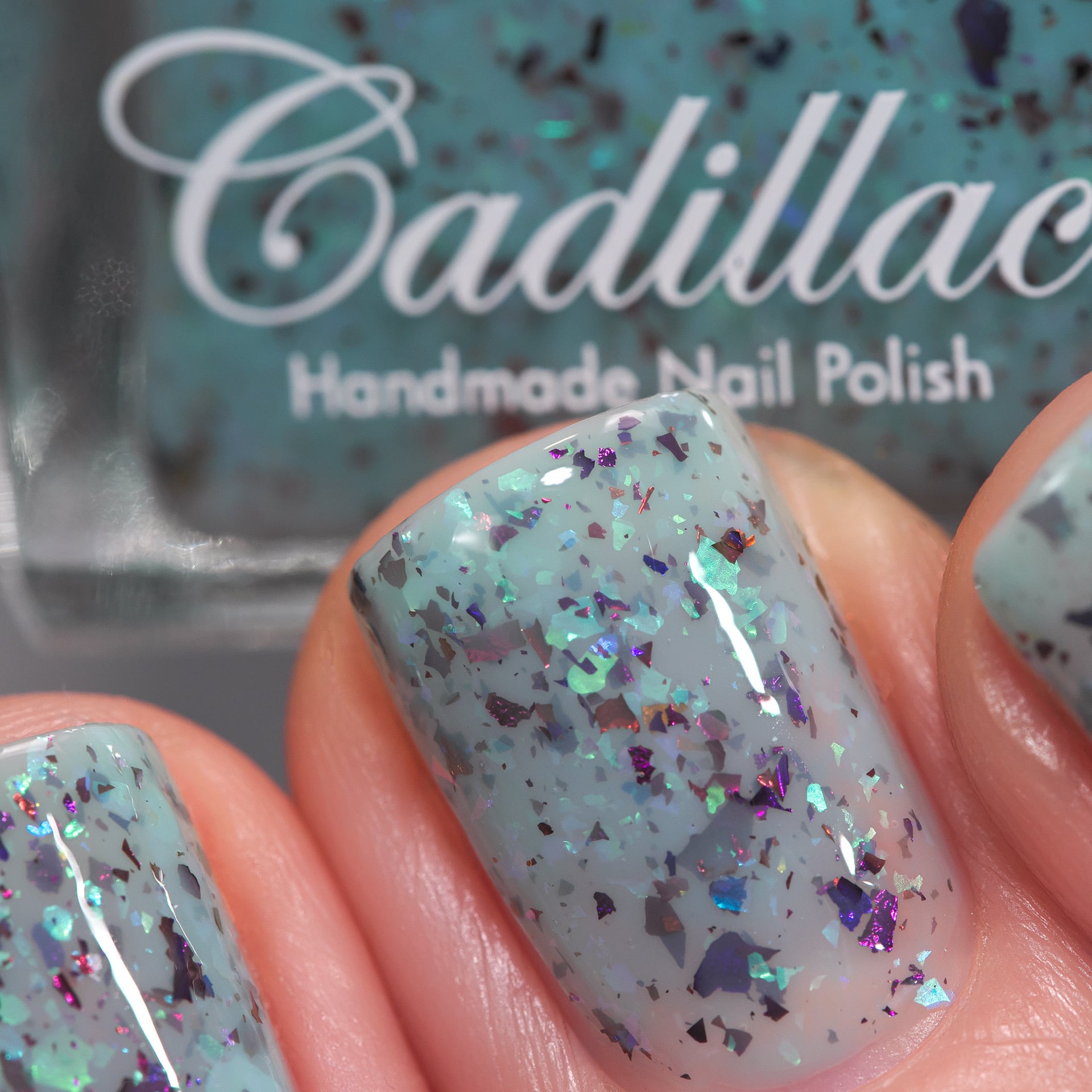 Cadillacquer Pastel Thoughts pastel teal purple chameleon iridescent crelly nail polish, swatched on three nails, light skin, studio lighting