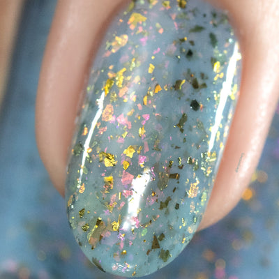 Cadillacquer Slow Mornings light blue gold chameleon iridescent crelly nail polish, macro single-nail swatch, light skin, studio lighting