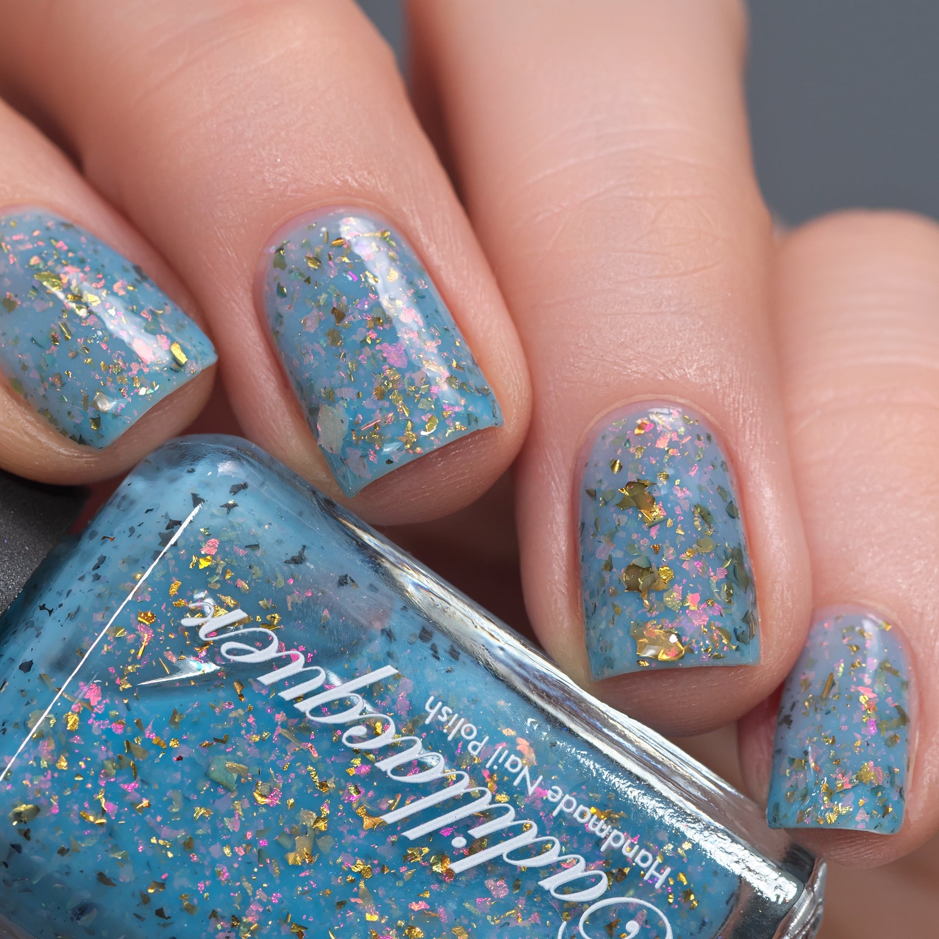 Cadillacquer Slow Mornings light blue gold chameleon iridescent crelly nail polish, swatched on four nails, light skin, studio lighting