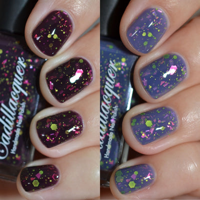 Thermal glitter and flake Cadillacquer nail polish in Strange Happenings, shown in both cold state (blackened eggplant) and warm state (dusty blue-grey) across eight squoval nails with vivid neon green matte glitter hexagons and hot pink iridescent flakes throughout, on light skin tone, studio lighting, swatched by @caitlinswatches