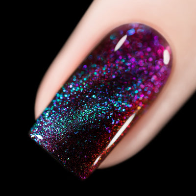 Close-up of Cadillacquer The Darkest Night nail polish showing teal and purple magnetic flakies over a black-red multichrome, swatched by @rafinails
