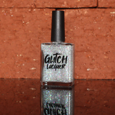 Be Gay, Do Crime by Glitch Lacquer, silver holographic reflective glitter and rainbow flake topper, bottle