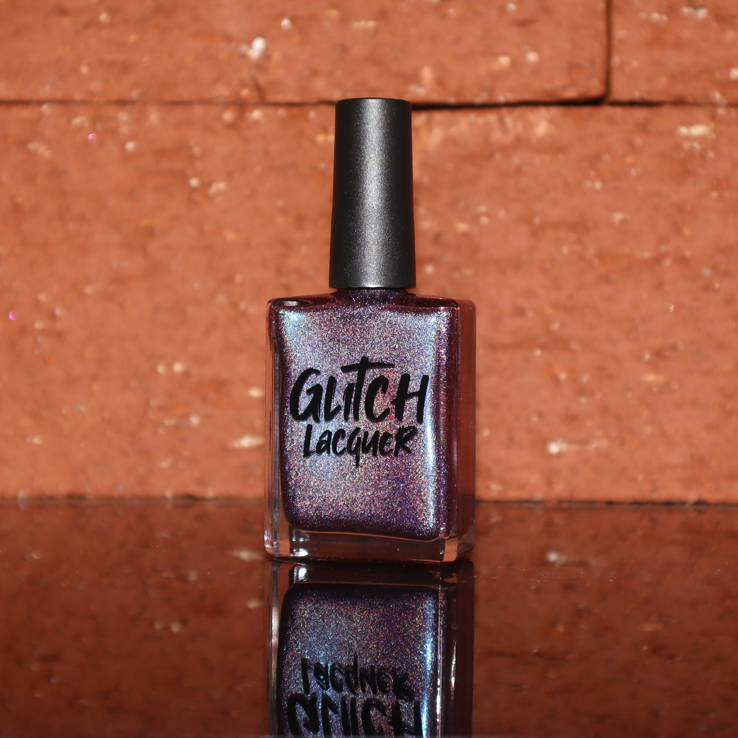 Bi Panic by Glitch Lacquer, magenta jelly with blue-to-purple glow and linear holographic, bottle
