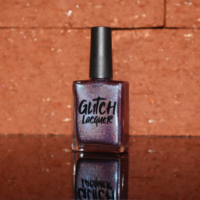 Bi Panic by Glitch Lacquer, magenta jelly with blue-to-purple glow and linear holographic, bottle