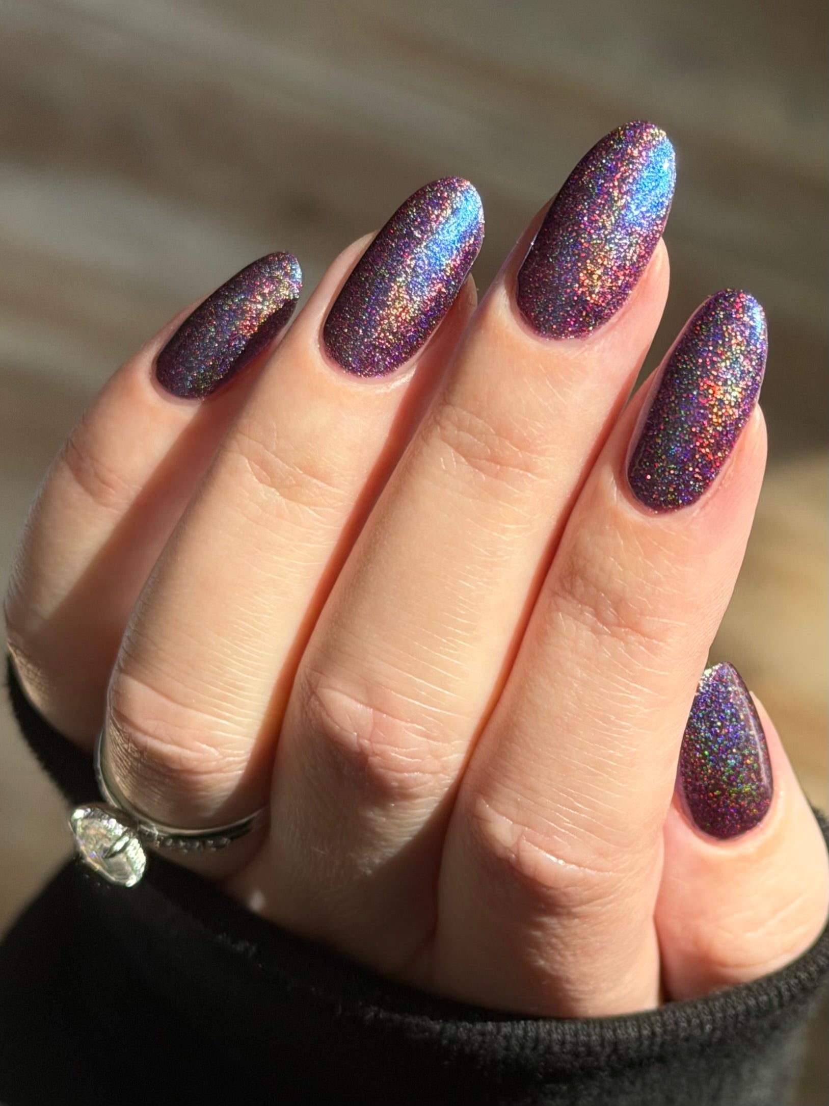 Bi Panic by Glitch Lacquer, magenta jelly, blue-to-purple glow, linear holographic, on light skin tone almond nails