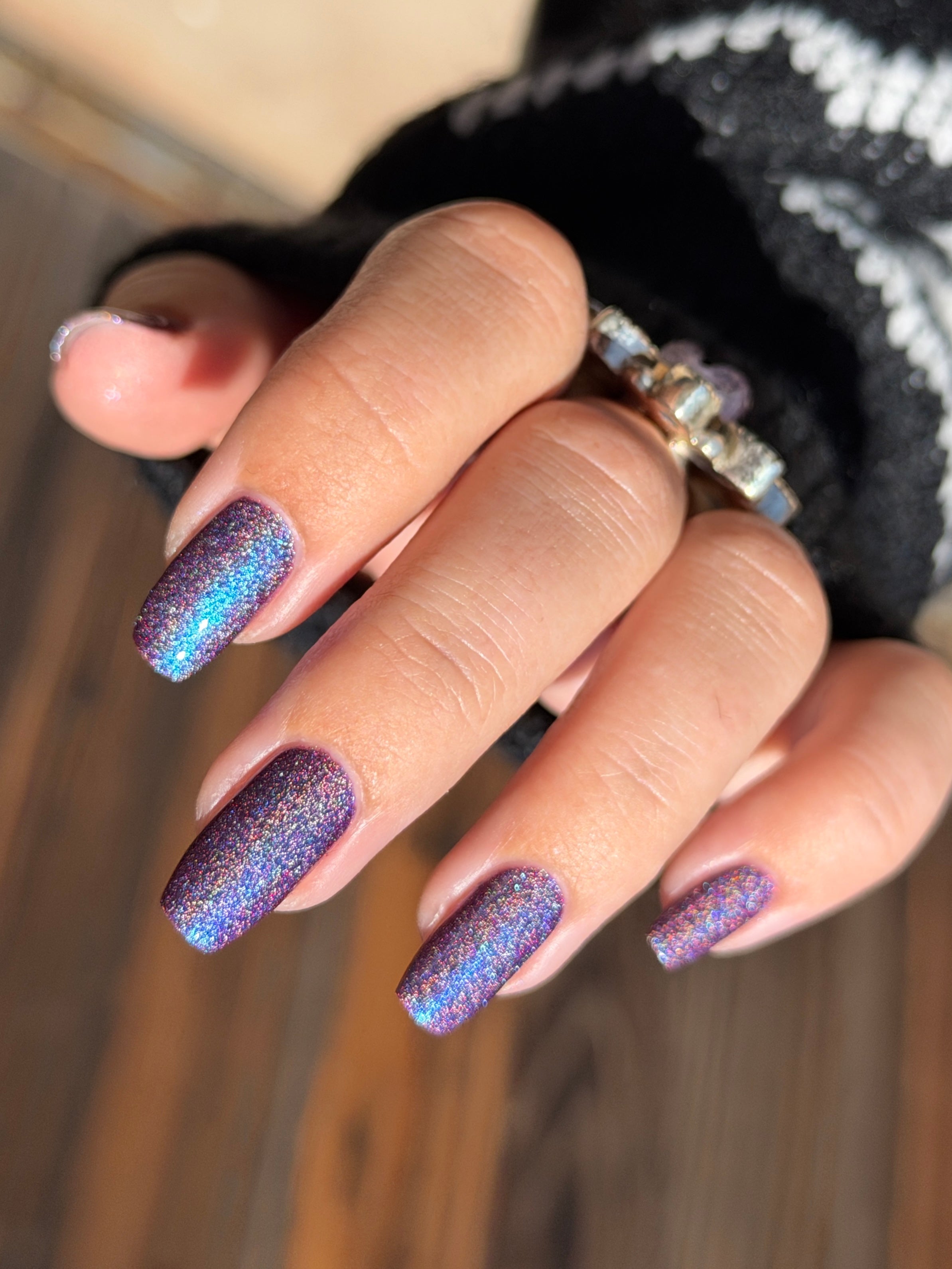 Bi Panic by Glitch Lacquer, magenta jelly, blue-to-purple glow, linear holographic, on light-medium skin tone square nails