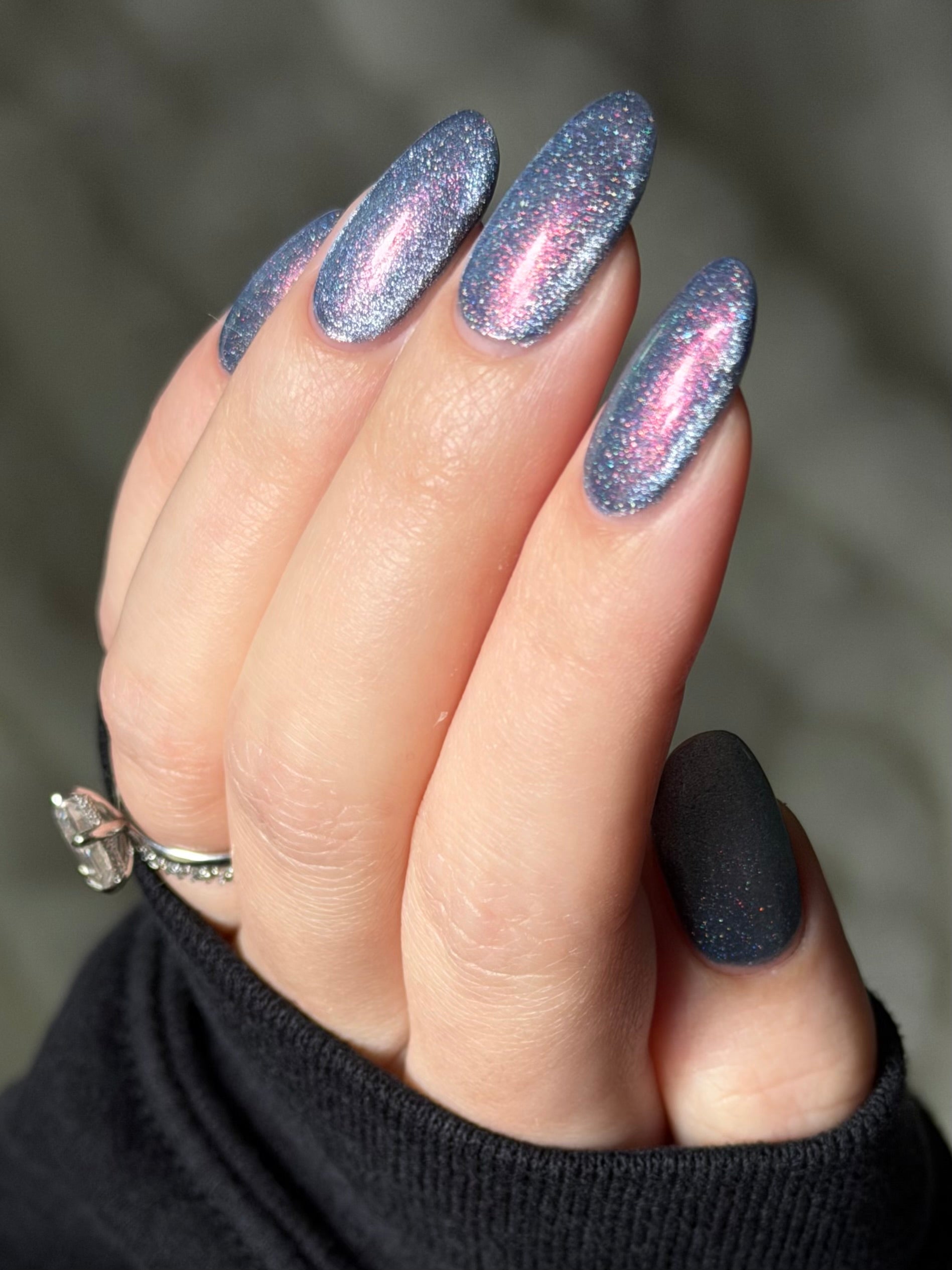 Protect the Dolls by Glitch Lacquer, blue jelly with color-shift shimmer and silver magnetic, on light skin tone almond nails
