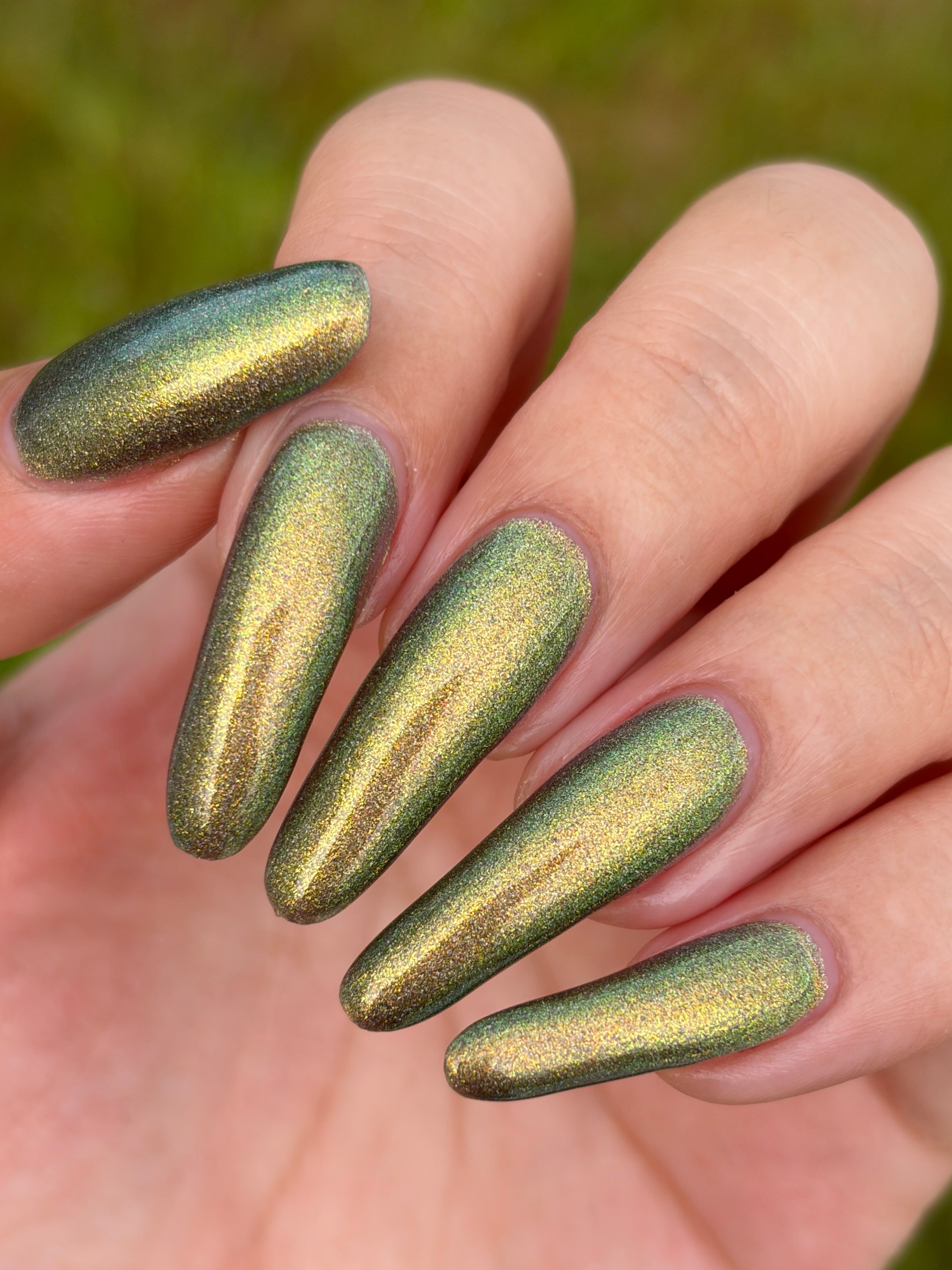 Safe House Glow by Glitch Lacquer, grey base, gold-to-teal multichrome shift, holo shimmer, on light-medium skin tone nails