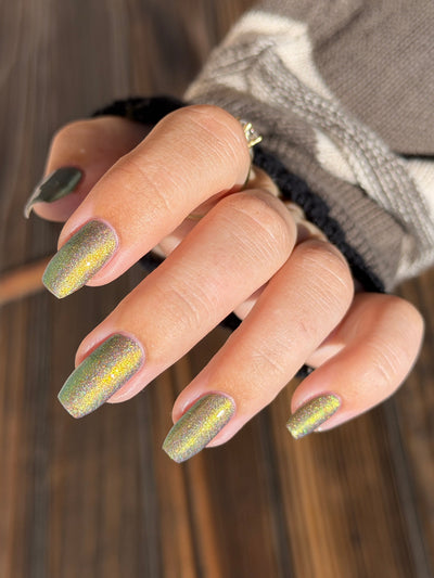 Safe House Glow by Glitch Lacquer, grey, gold-to-teal multichrome shift, holo shimmer, light-medium skin tone coffin nails