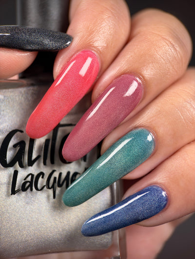 Ally by Glitch Lacquer, silver holographic magnetic topper layered over several base colors, on light-medium skin tone nails