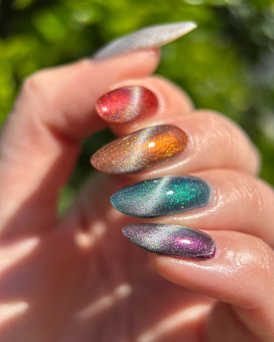 Ally by Glitch Lacquer, silver holographic magnetic topper, multichrome cat-eye over varied bases, on light-medium skin tone nails