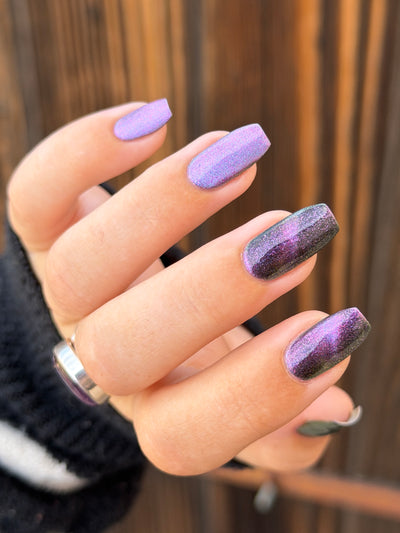 Lavender Menace by Glitch Lacquer, black jelly, purple sparkle, purple-blue magnetic, on light-medium skin tone square nails