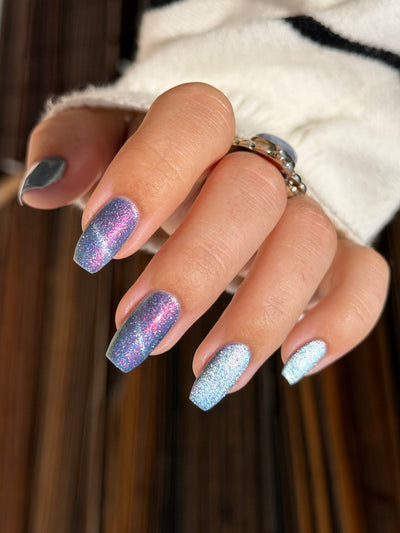 Protect the Dolls by Glitch Lacquer, blue jelly, color-shift shimmer, silver magnetic, light-medium skin tone coffin nails
